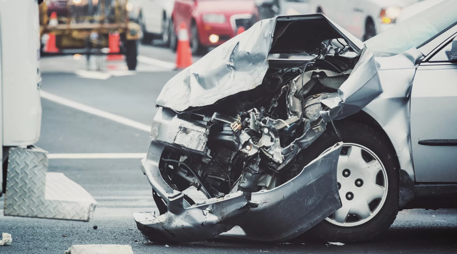 Front end of a car bumper crumpled after a car crash